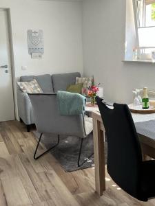 a living room with a couch and a table and chairs at Ferienwohnung Jardin de lavande in Fridingen an der Donau