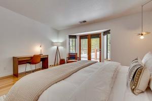 a white bedroom with a large bed and a desk at Private Ski, Lake & Golf Chalet! Walk to Lake in Tahoe Vista