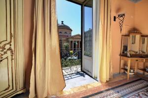 an open door to a balcony with a view of a building at Al Massimo Piacere in Palermo