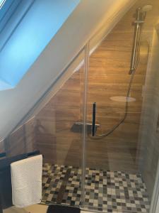 a bathroom with a shower under the stairs at Ferienwohnungen am Klosterberg in Bad Neuenahr-Ahrweiler +15 photos