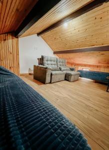 a living room with a couch in a room with wooden ceilings at Apartamentos Dumont in Monte Verde