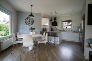 a kitchen and dining room with a table and chairs at Guest house TOMAN in Bled +41 photos