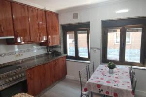 a kitchen with a table and a dining room at apartamento a 19min de Gijón y 15 de Oviedo in Langreo