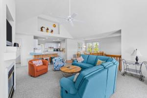 a living room with two blue couches and a table at Cherished Memories in Nags Head
