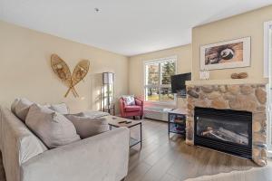 a living room with a couch and a fireplace at Polar Peaks Hot Tub Pool Gas Fireplace in Radium Hot Springs