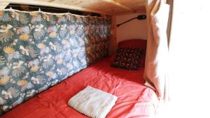 a small room with a bed in the back of a tent at Seignosse : Mandago Surf Home in Seignosse