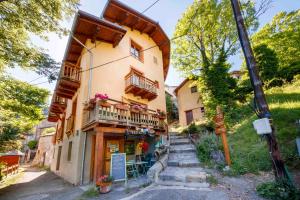 a building with balconies and stairs in front of it at Eco-hôtel et Yourtes du Mercantour in Guillaumes