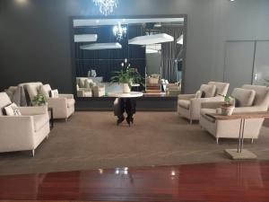 a waiting room with couches and a table in the middle at The Franklin Loft Apartments Unit 1209 in Johannesburg