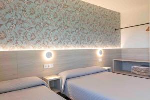 Hotel Leal - La Sirena tesisinde bir odada yatak veya yataklar