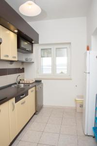 a kitchen with a sink and a refrigerator at Apartment Silvana in Senj