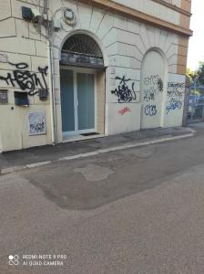 a building with graffiti on the side of it at Casa Dori in Rome