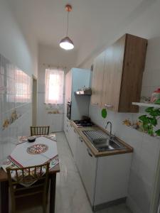 a small kitchen with a sink and a table at Casa Vacanze l' angolo dei Mori in Termini Imerese