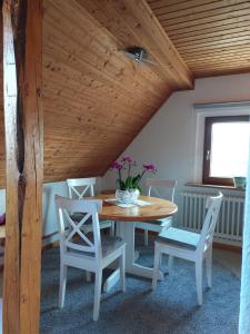 Un comedor con mesa y sillas de madera. en Dachgeschosswohnung mit Burgblick in Kues, en Bernkastel-Kues