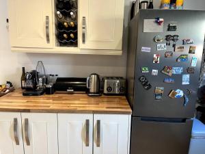 a kitchen with a refrigerator with magnets on it at Stay in the heart of West Kirby in West Kirby