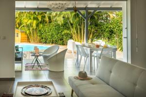 a living room with a couch and a table at Villa Kokomo - St. Francis, completely renovated in Saint-François