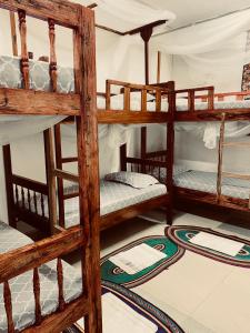 a room with four bunk beds in a house at Sanaa Hostel in Zanzibar City