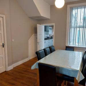 a dining room with a table and some chairs at Woodstock Townhouse Belfast in Belfast