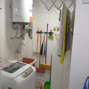 a bathroom with a washing machine and a sink at Apartamento BREÑA in Lima