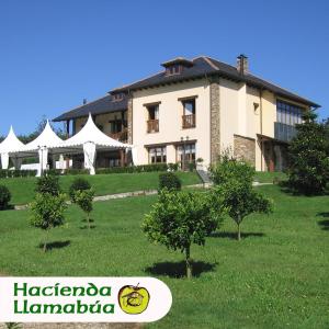 a large building with trees in front of it at Hotel Hacienda Llamabua in Navia
