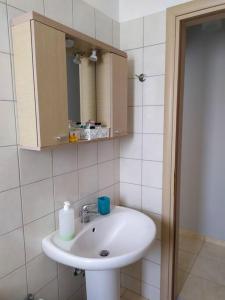 a bathroom with a sink and a mirror at Wabi Sabi house in Ierápetra