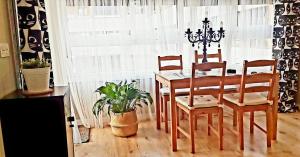 a dining room with a table and two chairs at COSTA NORTE Apartamento con Terraza Garaje y Piscina in Castro-Urdiales