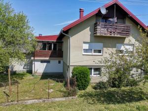 a large house with a red roof at Appartement Drava 1 in Donja Dubrava