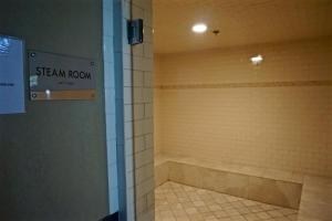 a bathroom with a shower with a sign on the wall at Silver Rock Condominiums by Fernie Central Reservations in Fernie
