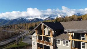 an apartment building with a view of the mountains at Silver Rock Condominiums by Fernie Central Reservations in Fernie
