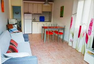 a living room with a couch and a table and a kitchen at Menorca beach in Cala Galdana