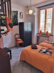 a room with two beds and a chair in it at CasarinoLaurino Valle Del Golfo Healthy Air Hills And Sea in Uscio