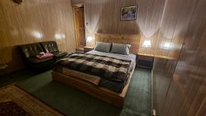 a bedroom with a bed and a couch in it at Sehrish Guest House Skardu in Skardu