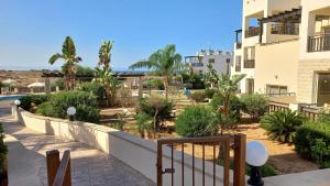 a view from the balcony of a building with trees and plants at Modern Studio apartment Armonia Court in Paralimni