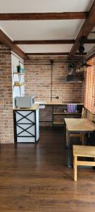 a kitchen with a counter and a brick wall at Квартира Люкс (Мира 1) in Balqash