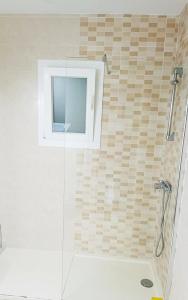 a shower with a glass door in a bathroom at Galdana Sun And Beach in Cala Galdana