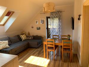 a living room with a table and a couch at Apartamenty ANNA in Brenna