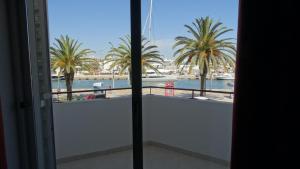 a view of a harbor from a balcony with palm trees at Casa Avenida in Lagos