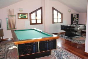 a room with a pool table and a piano at Villa Marta in Santillana del Mar