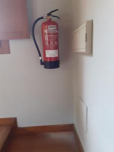 a fire extinguisher hanging on a wall in a kitchen at Aromas de Coraín in Cangas de Onís