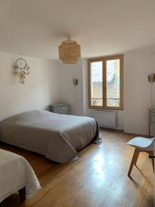 a bedroom with a bed and a window at Colmars les Alpes in Colmars