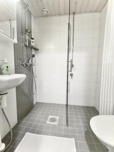 a bathroom with a shower and a sink at Travel Center Studio in Pori