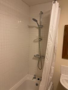 a bathroom with a shower with a tub at Spacious 8 bed house Kirkby in Ashfield Nottingham in Kirkby in Ashfield