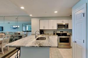 a kitchen with a sink and a counter top at The Pearl Of Navarre 705 in Navarre