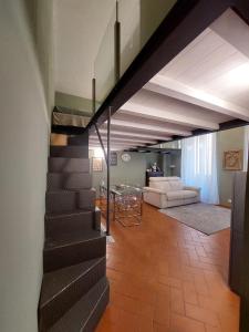 a staircase in a living room with a couch and a table at Green Pepper Apartment in Florence in Florence