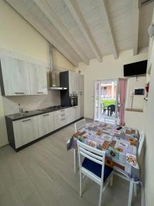 a kitchen with a table and chairs in a room at Casa Tortora in Gravedona