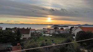 a view of a town with the sunset in the background at Francis Appartements in Pakoštane