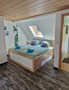 WiedaにあるFerienwohnung Am Berggipfelのベッドルーム1室(青いタオル付きのベッド1台付)