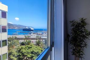 uma vista para o oceano a partir de uma janela num edifício em Céntrico apartamento con vistas em Santa Cruz de Tenerife