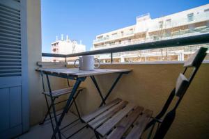 a table and two chairs on a balcony with a coffee cup at Appartement tout équipé balcon 4 pers St Charles in Marseille