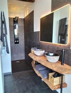 a bathroom with two sinks and a mirror at L'essens in Fayence
