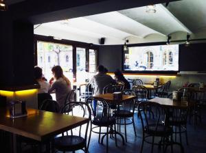 a group of people sitting at tables in a restaurant at The Hotel 592 - Adults Only in Barcelona